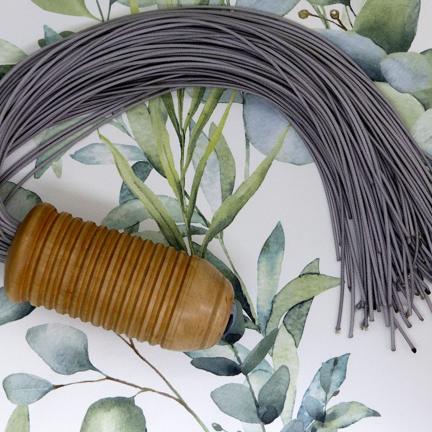 Wood handled flogger with grey falls